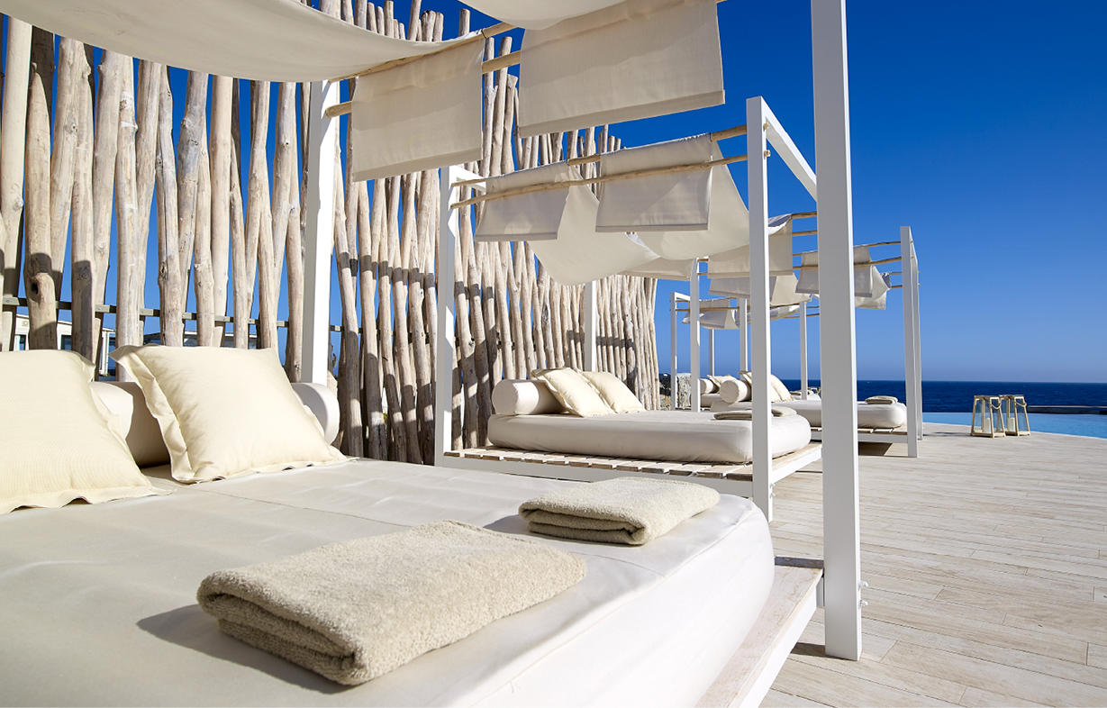 Sunbeds_swimming_pool__summer_sunny_days_sunbathing__Artemis_Deluxe_Rooms_Milos_island_Cyclades_Greece